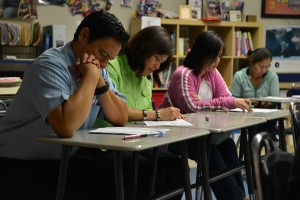 Parents taking tests made by students in Ms.Chaicharee's classroom. Photo credit: Ashley Le