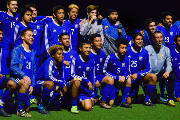 Nicholas Cardenas ('16, center, number 3) celebrates with his teammates after scoring the winning goal in extra time. 