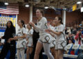 Fountain Valley Barons girl's basketball team cheer on their teammates during a home game.