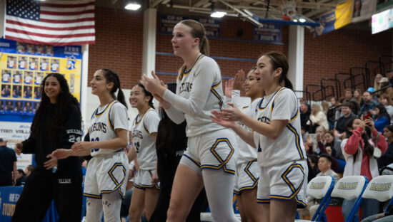 Fountain Valley Barons girl's basketball team cheer on their teammates during a home game.
